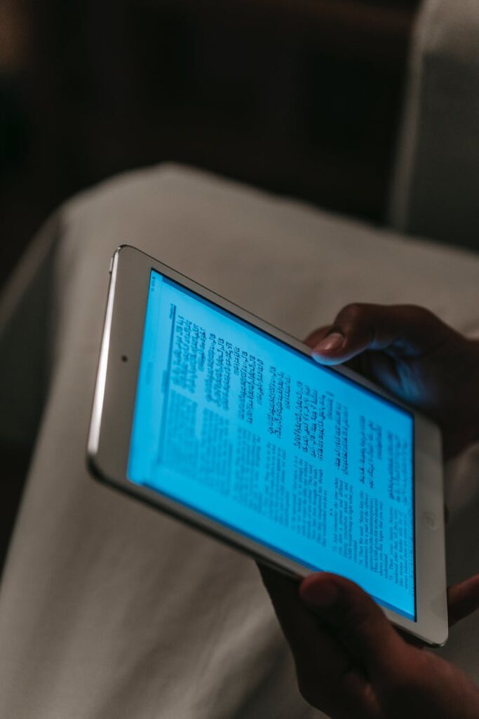 person using tablet in dark room