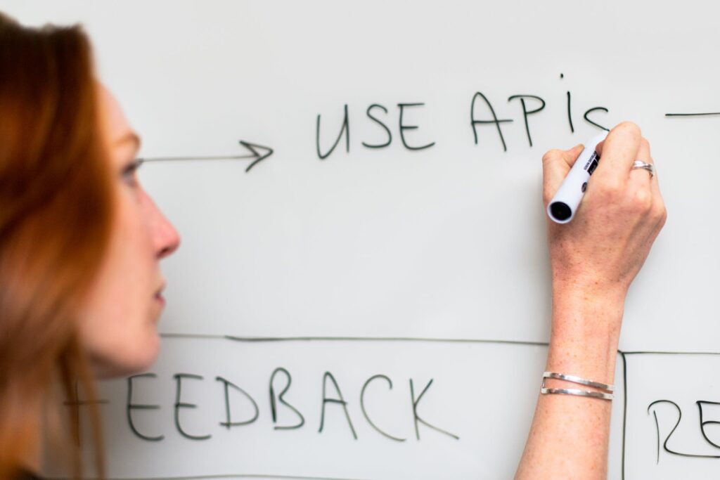 woman writing on whiteboard